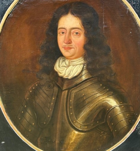 A seventeenth-century oil painting on canvas depicting a gentleman in dark plate armour, set within an oval spandrel inside a decorative giltwood frame. View IV