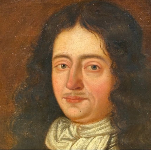 A seventeenth-century oil painting on canvas depicting a gentleman in dark plate armour, set within an oval spandrel inside a decorative giltwood frame. View VII