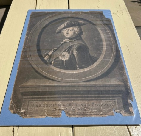 An 18th-century monochrome mezzotint print depicting a bust portrait of Frederick King of Prussia set within a stone oval frame. View X