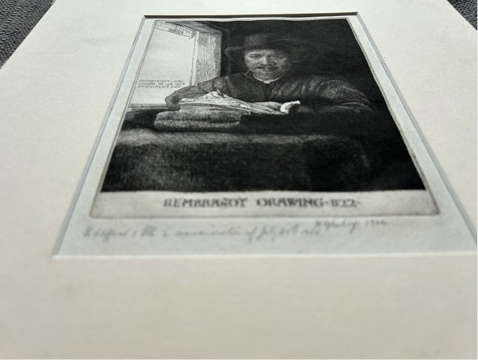 A monochrome etching depicting a man in a wide-brimmed hat seated at a window writing on a stack of paper, signed along the lower border. View XI