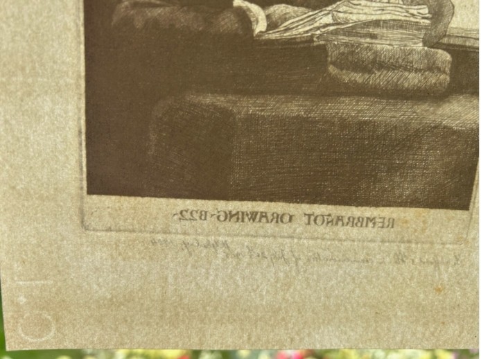A monochrome etching depicting a man in a wide-brimmed hat seated at a window writing on a stack of paper, signed along the lower border. View XII