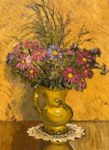 A mid-20th century oil painting on board featuring pink and purple flowers in a yellow pitcher against a textured ochre background, presented in a wooden frame. View II