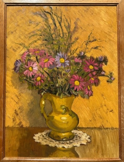 A mid-20th century oil painting on board featuring pink and purple flowers in a yellow pitcher against a textured ochre background, presented in a wooden frame. View III