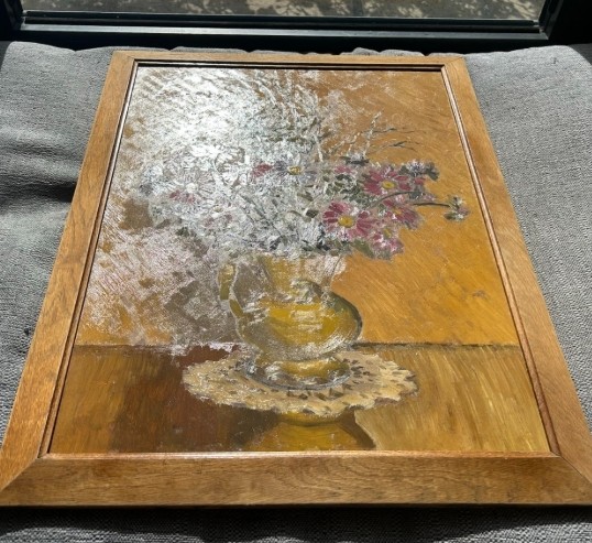 A mid-20th century oil painting on board featuring pink and purple flowers in a yellow pitcher against a textured ochre background, presented in a wooden frame. View IV