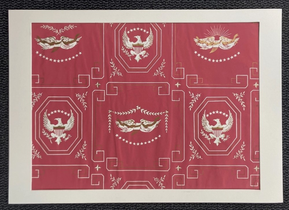 Crimson red hand-printed wallpaper panel featuring white and gold American eagle motifs within octagonal panels, laurel swags, and geometric borders. View IV