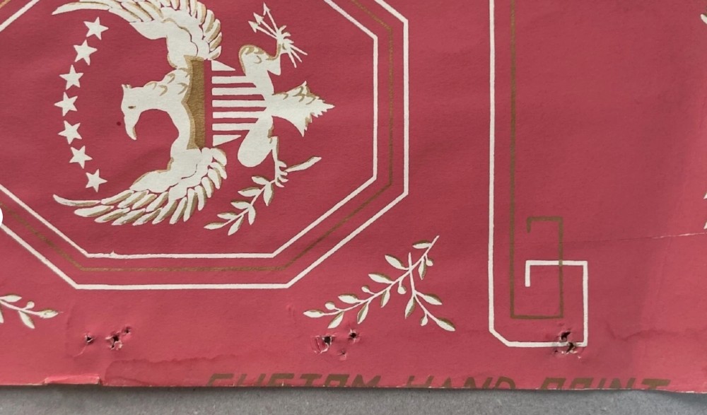 Crimson red hand-printed wallpaper panel featuring white and gold American eagle motifs within octagonal panels, laurel swags, and geometric borders. View IX