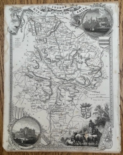 A steel engraved monochrome map of Huntingdonshire by Thomas Moule dated circa 1840 with heraldic crests and topographical vignettes.