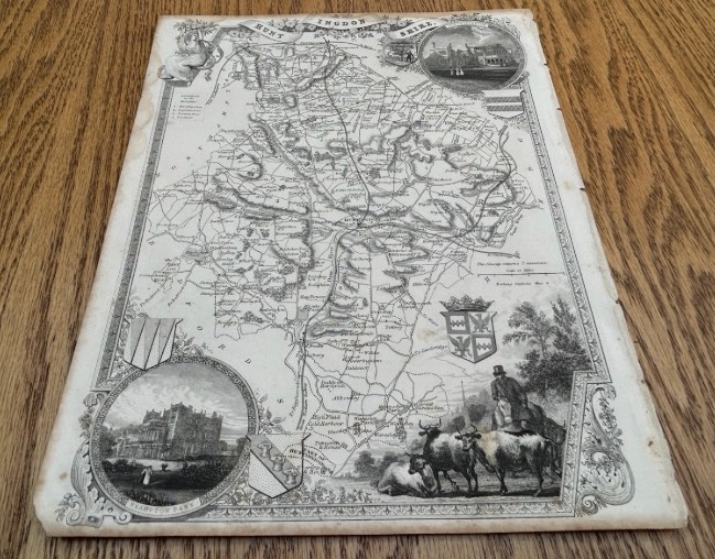 A steel engraved monochrome map of Huntingdonshire by Thomas Moule dated circa 1840 with heraldic crests and topographical vignettes. View II