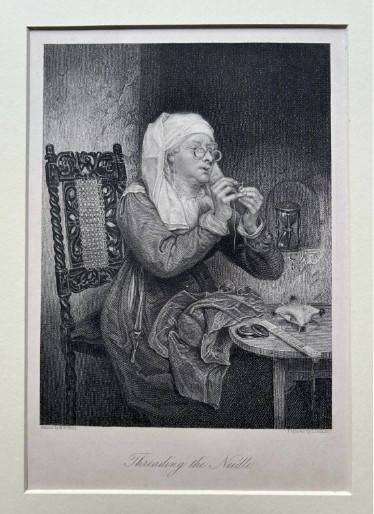 A monochrome nineteenth-century steel engraving depicting an elderly woman wearing spectacles and a headscarf threading a needle while seated at a small wooden table. View III