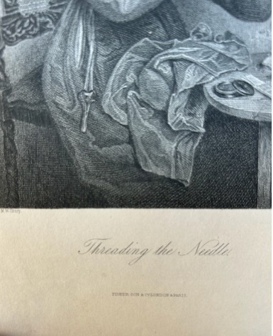 A monochrome nineteenth-century steel engraving depicting an elderly woman wearing spectacles and a headscarf threading a needle while seated at a small wooden table. View IX