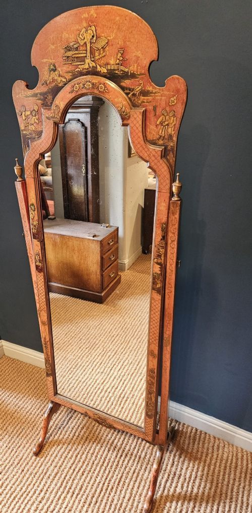 A tall 1920s Chinoiserie freestanding cheval mirror featuring an arched frame decorated with gold hand-painted Asian figures and landscapes on a warm terracotta lacquered background. View VII