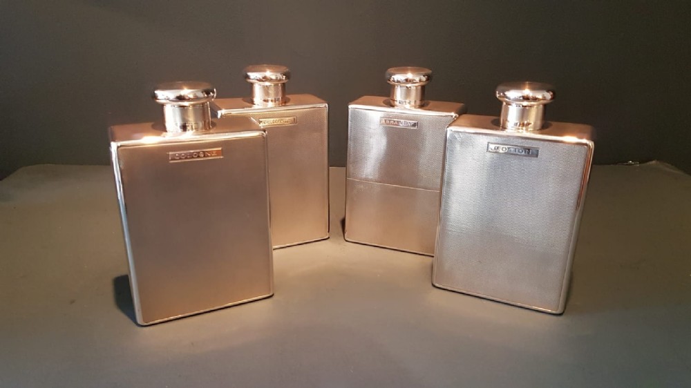 Set of Four Engine Turned Silver Flasks
