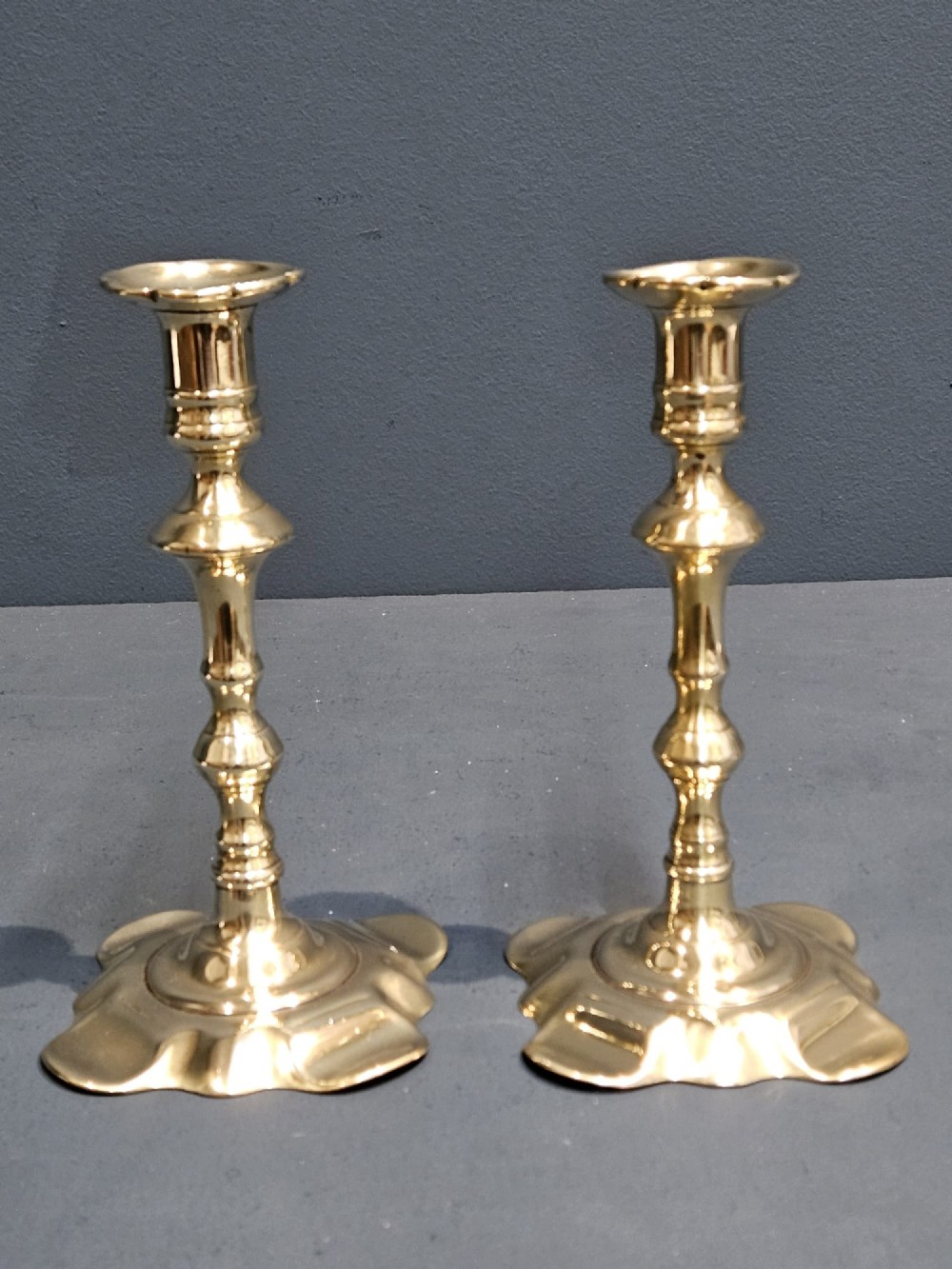 Pair of George III Brass Petal Base Candlesticks