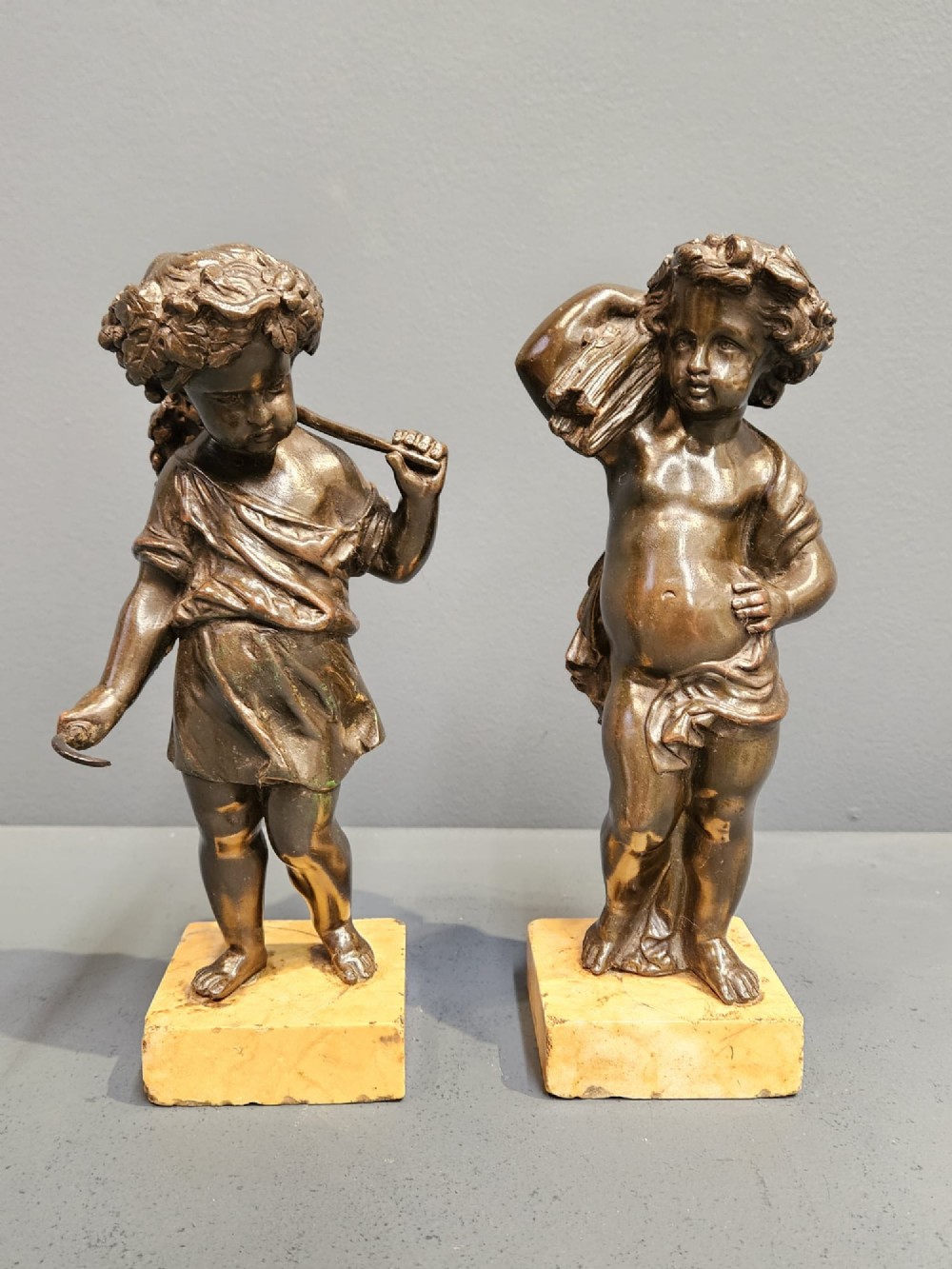 Pair of Bronze Cherub Wheat Gatherers