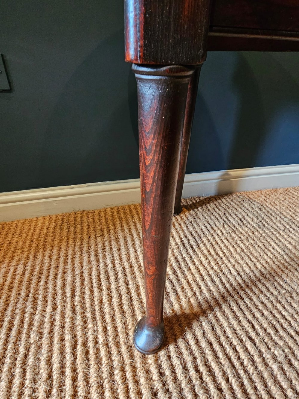 A round Georgian elm cricket table with three tapered legs terminating in pad feet and a triangular deep apron. View IV