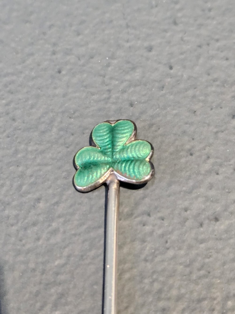A set of eight silver cocktail sticks with colourful enamelled floral finials displayed inside a black silk and velvet-lined presentation box. View III
