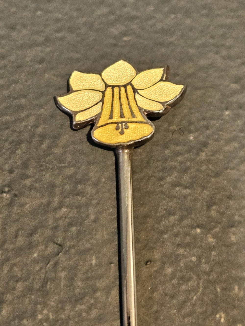 A set of eight silver cocktail sticks with colourful enamelled floral finials displayed inside a black silk and velvet-lined presentation box. View V