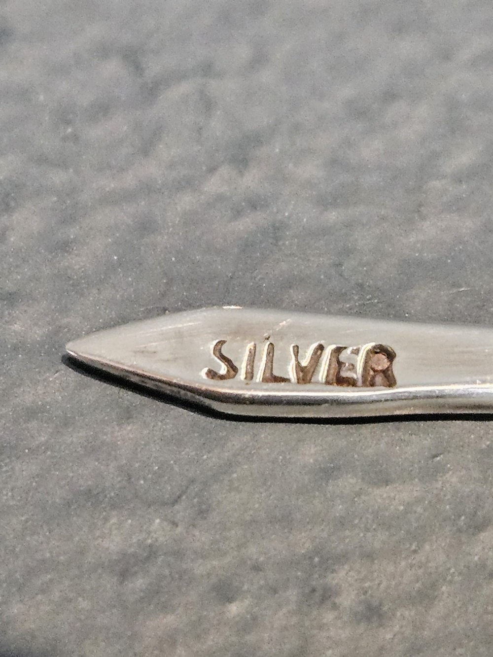 A set of eight silver cocktail sticks with colourful enamelled floral finials displayed inside a black silk and velvet-lined presentation box. View VI