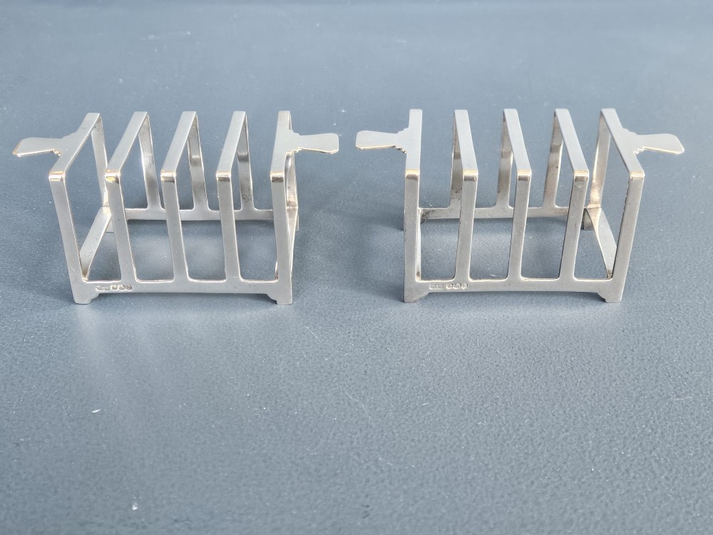 A matching pair of silver six-slice toast racks made by Mappin and Webb with geometric handles and stamped hallmarks. View II