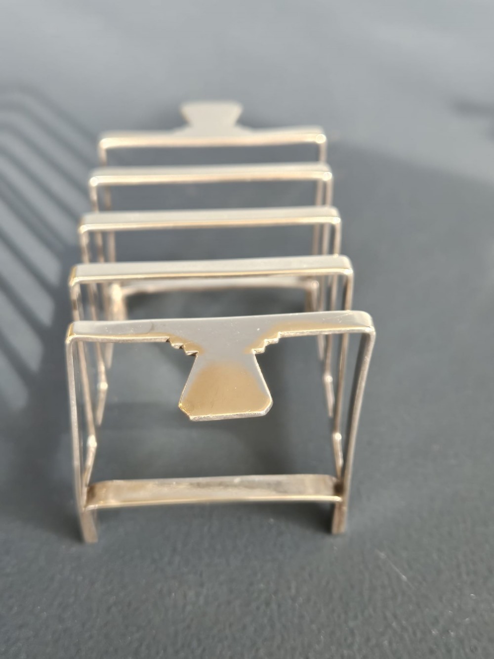 A matching pair of silver six-slice toast racks made by Mappin and Webb with geometric handles and stamped hallmarks. View IV