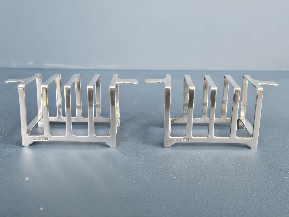 A matching pair of silver six-slice toast racks made by Mappin and Webb with geometric handles and stamped hallmarks. View V