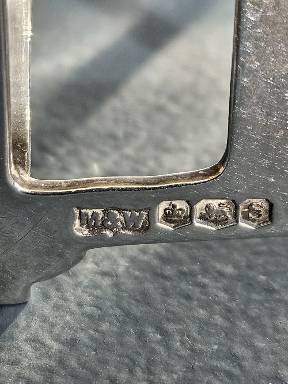 A matching pair of silver six-slice toast racks made by Mappin and Webb with geometric handles and stamped hallmarks. View VI