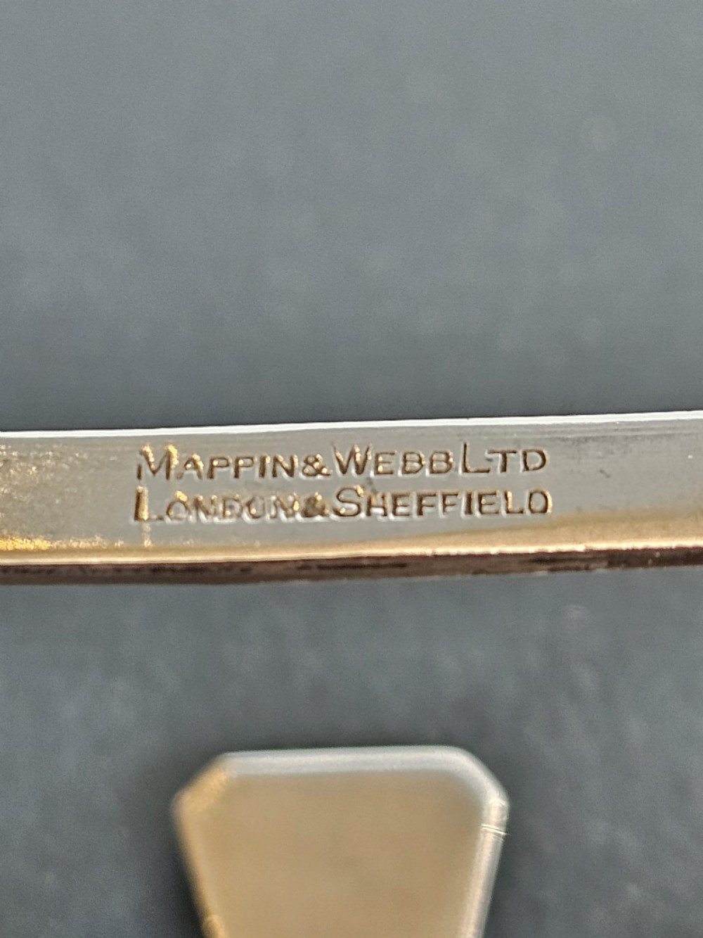 A matching pair of silver six-slice toast racks made by Mappin and Webb with geometric handles and stamped hallmarks. View VII