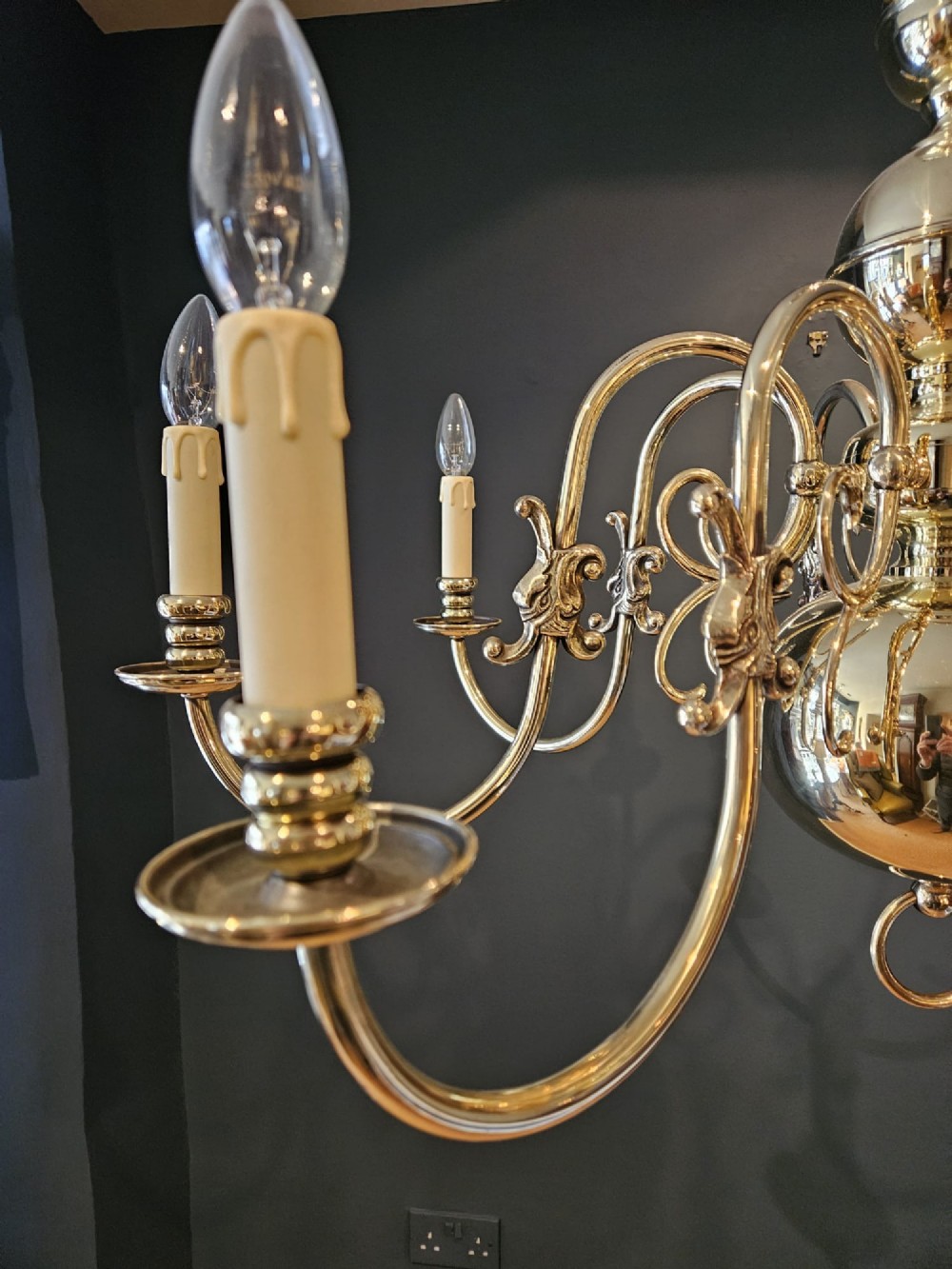 An Edwardian-style polished brass eight-arm chandelier featuring an eagle finial, central baluster stem, scrolling branches, and faux candle light sockets. View II