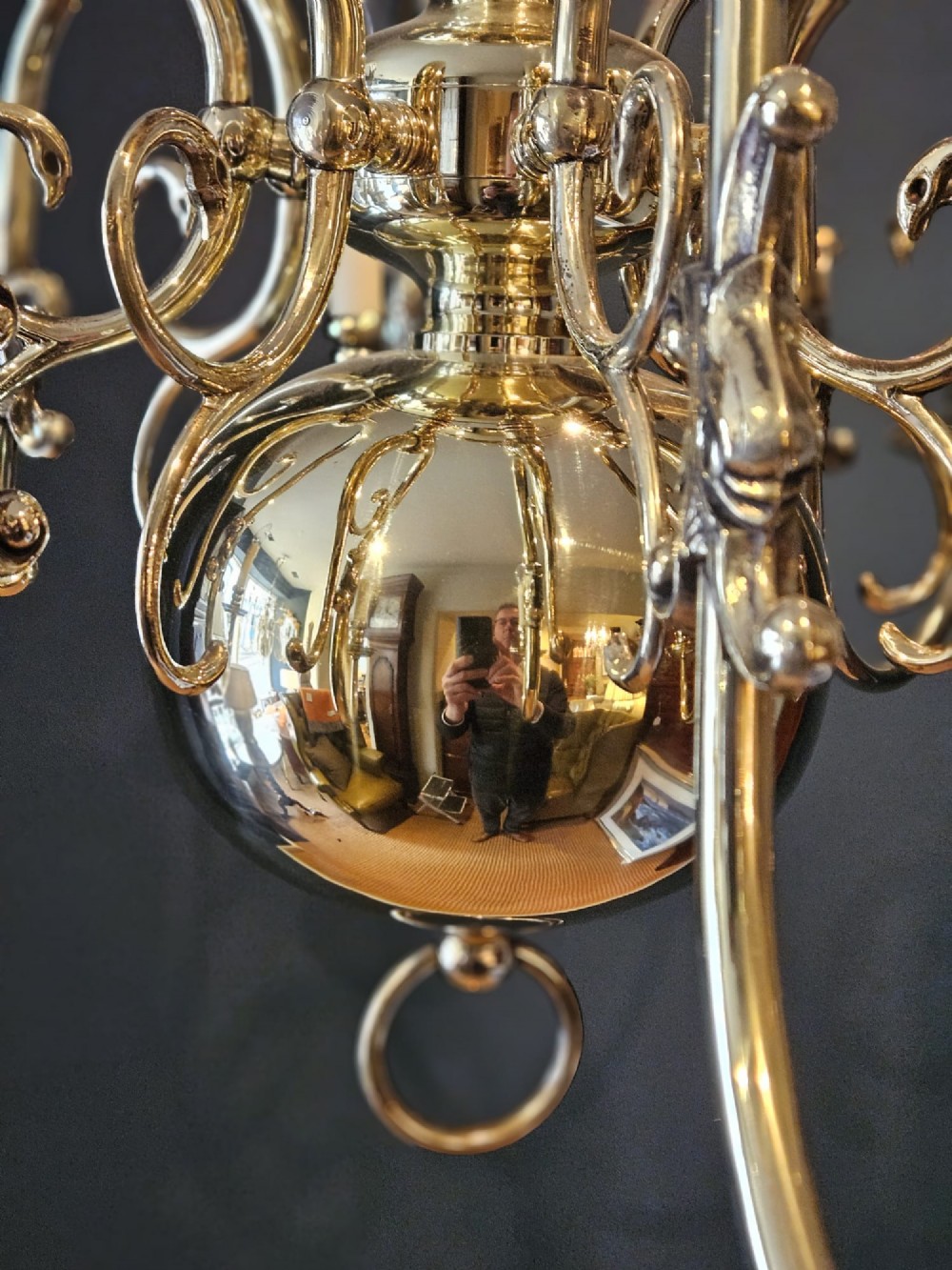 An Edwardian-style polished brass eight-arm chandelier featuring an eagle finial, central baluster stem, scrolling branches, and faux candle light sockets. View III