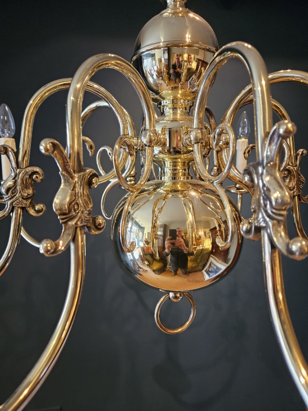 An Edwardian-style polished brass eight-arm chandelier featuring an eagle finial, central baluster stem, scrolling branches, and faux candle light sockets. View V