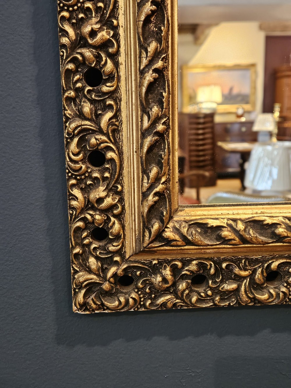 A large rectangular Victorian gilt mirror featuring a heavily carved timber frame with a gold leaf finish. View III