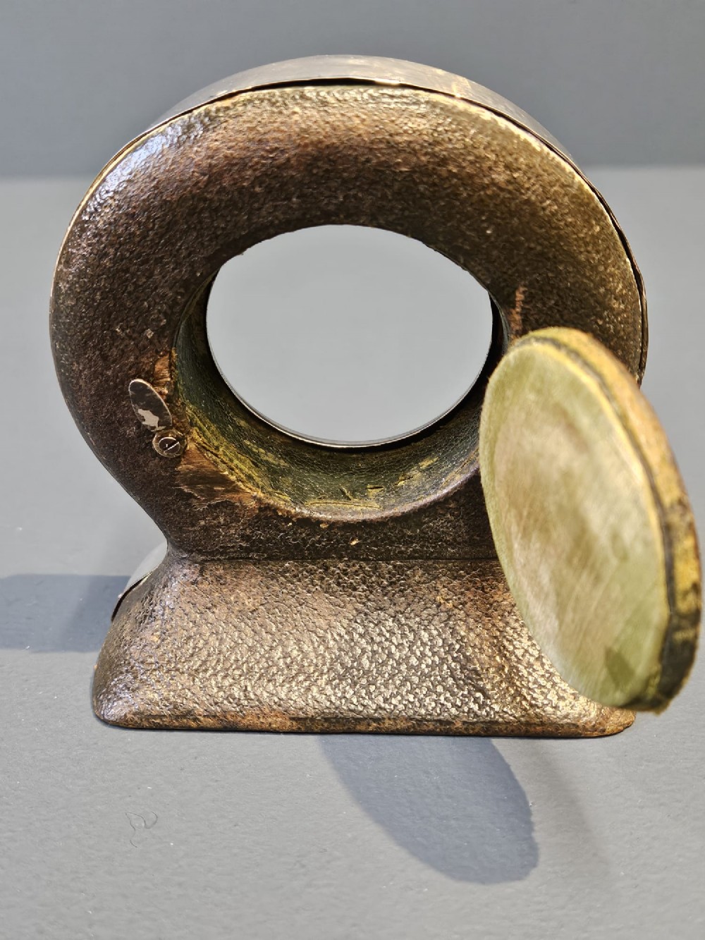 A circular sterling silver pocket watch holder with Chester hallmarks, featuring a recessed green velvet interior bezel and a shaped base. View IV
