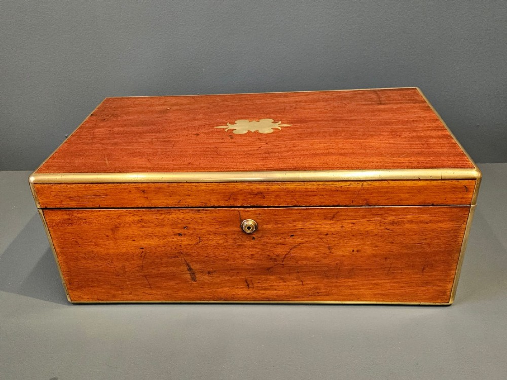 An open Victorian mahogany writing slope featuring a gold-tooled black leather insert, internal compartments, and an extended side drawer. View V