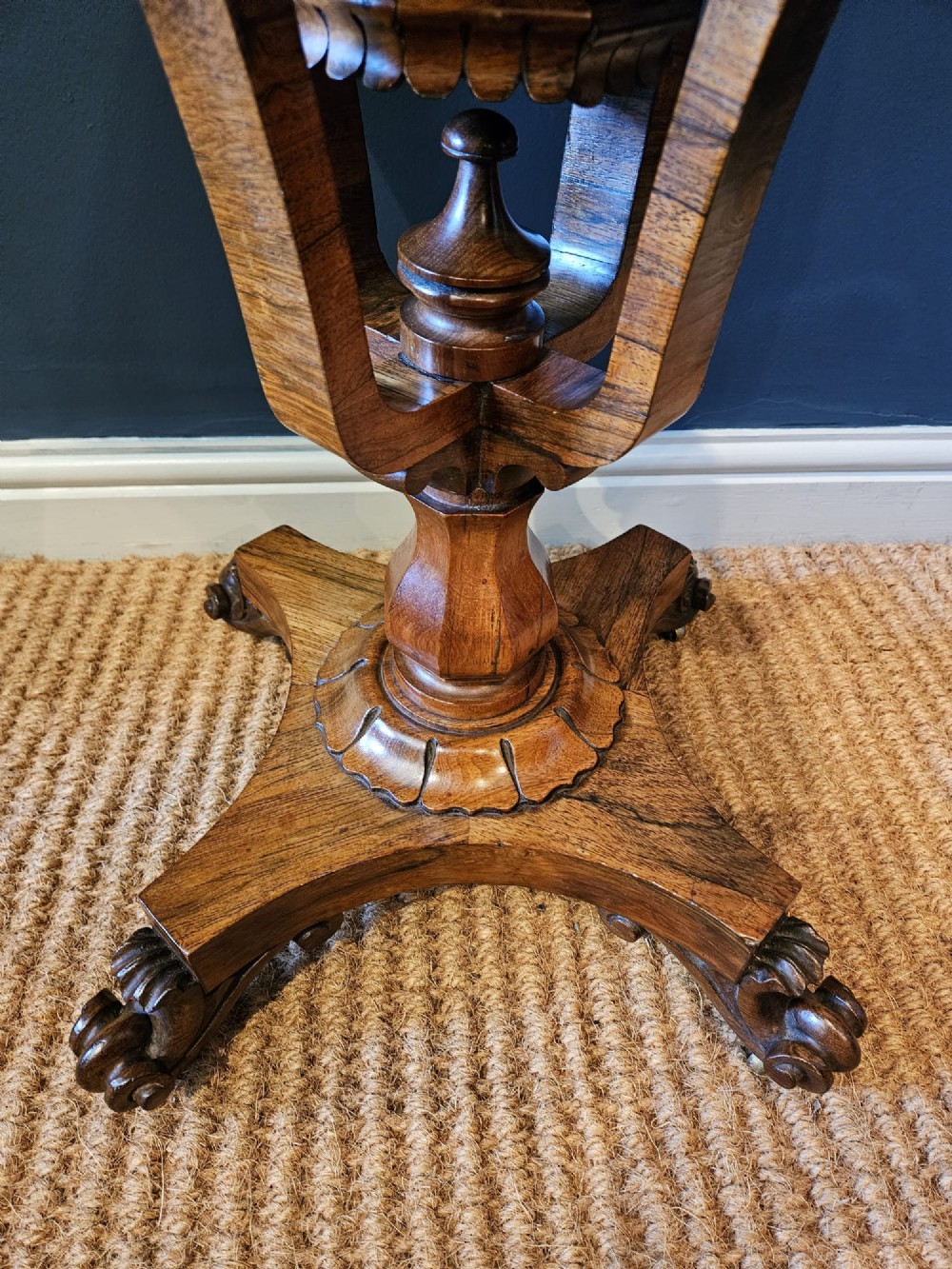 A William IV rosewood octagonal sewing work table featuring a tapered trumpet column supported by a carved quadform base with scroll feet. View III