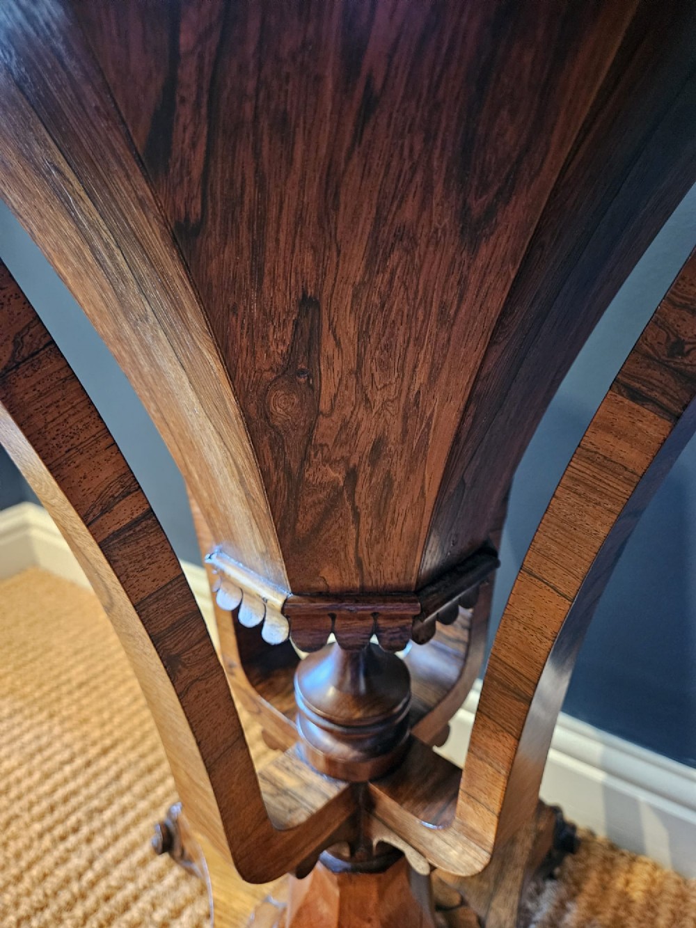 A William IV rosewood octagonal sewing work table featuring a tapered trumpet column supported by a carved quadform base with scroll feet. View VII