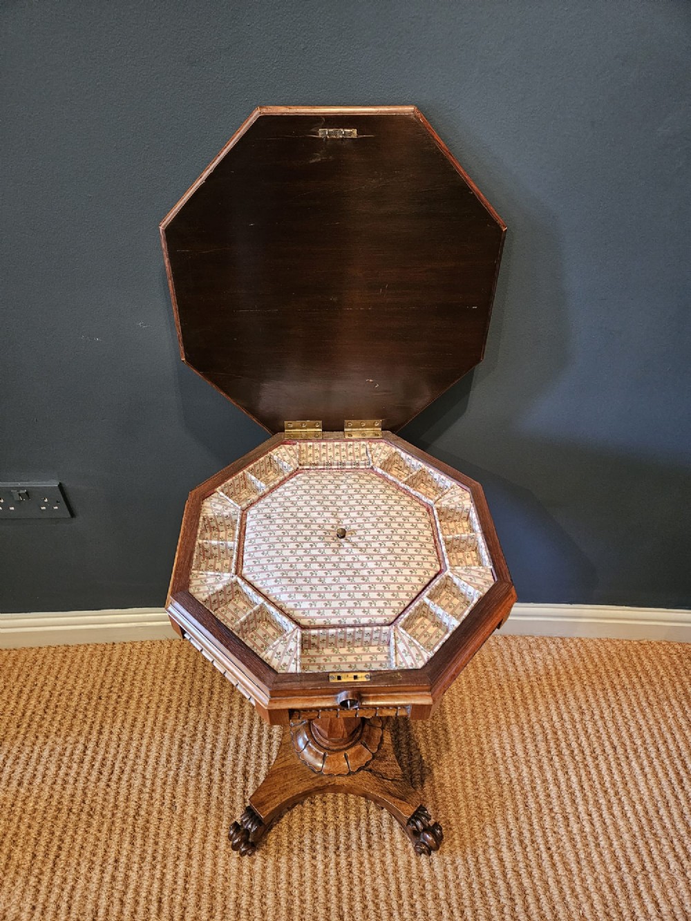 A William IV rosewood octagonal sewing work table featuring a tapered trumpet column supported by a carved quadform base with scroll feet. View VIII
