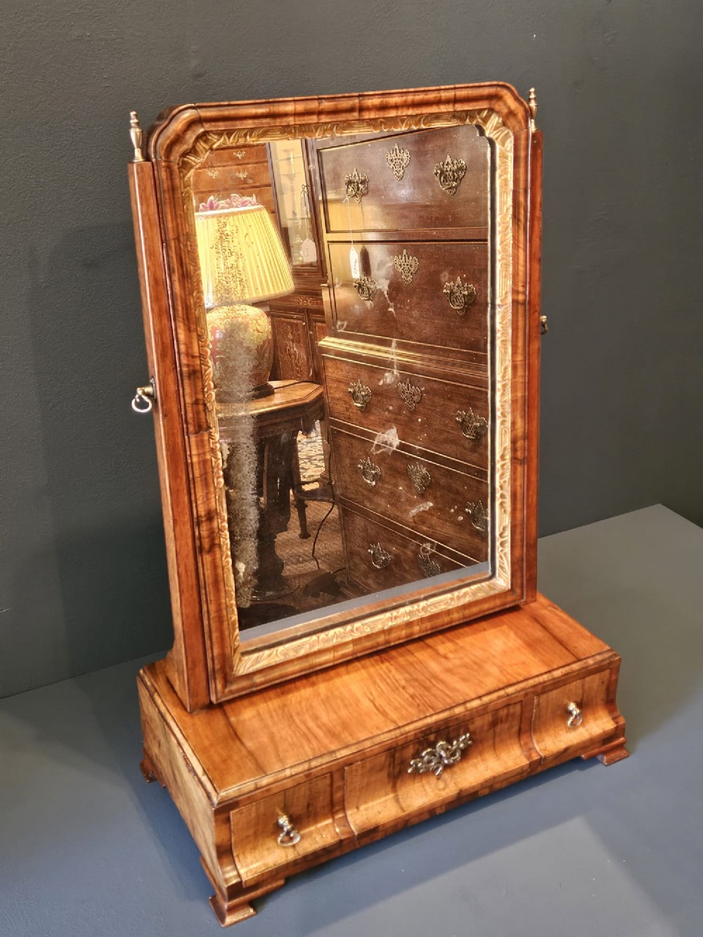 An 18th-century George II figured walnut toilet mirror featuring an adjustable frame with a gilded inner slip moulding above a single-drawer wooden base. View VIII