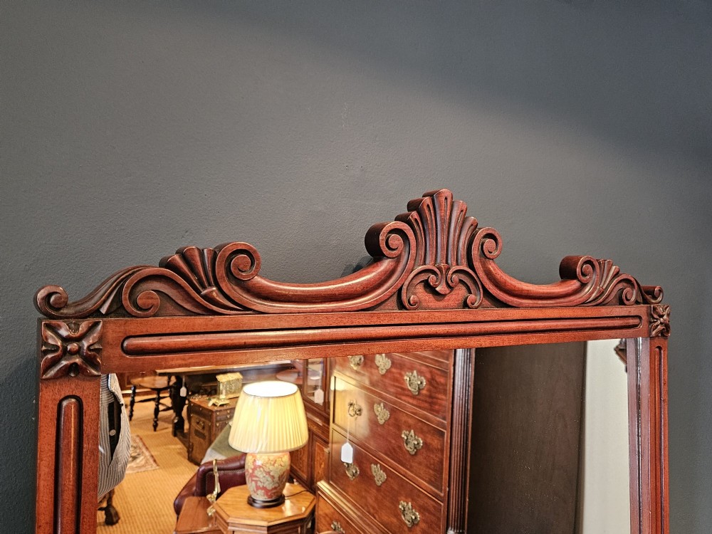 A rectangular Victorian mahogany wall mirror featuring a carved pediment crest and fluted side pillars. View II