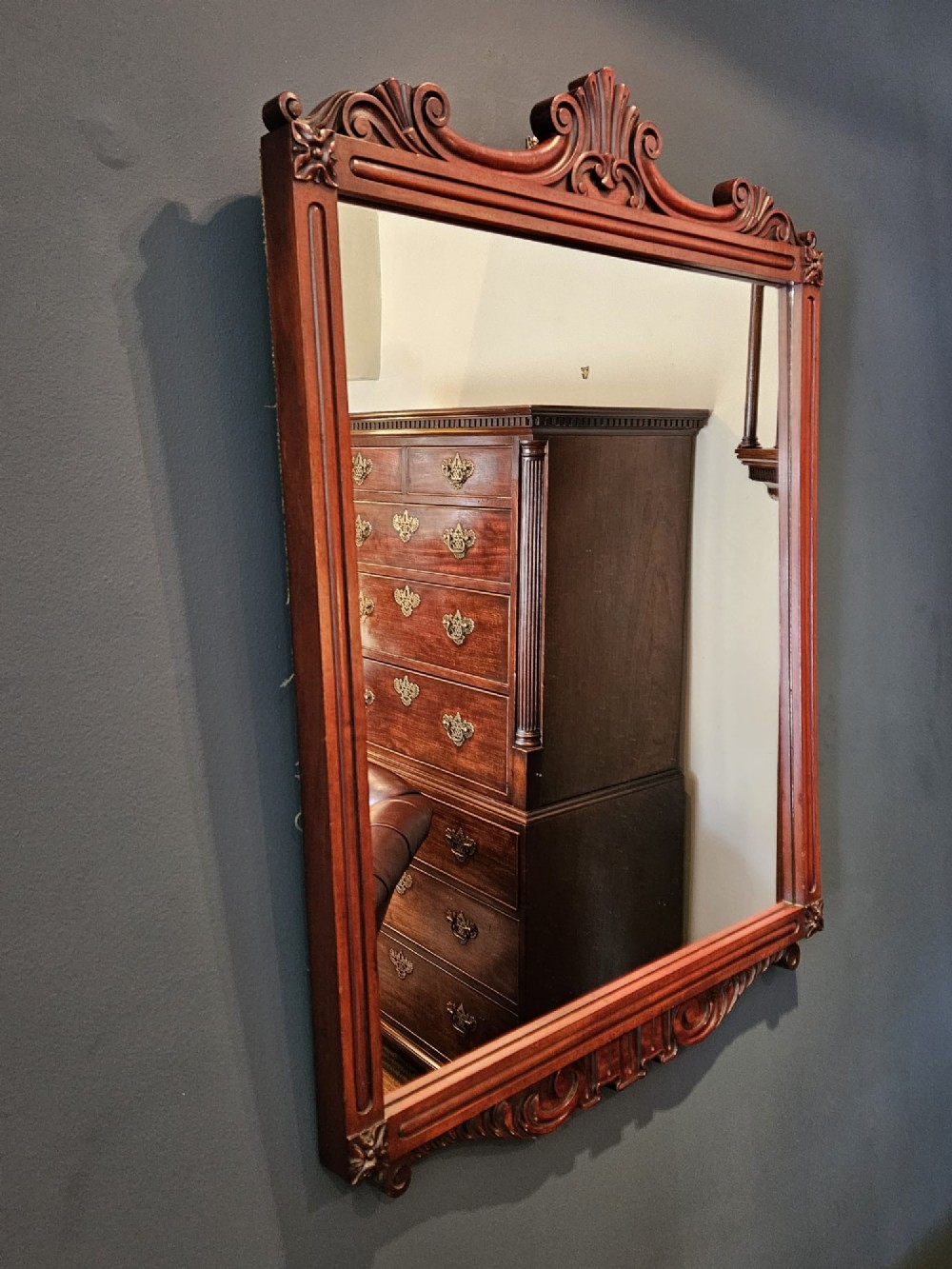 A rectangular Victorian mahogany wall mirror featuring a carved pediment crest and fluted side pillars. View VII