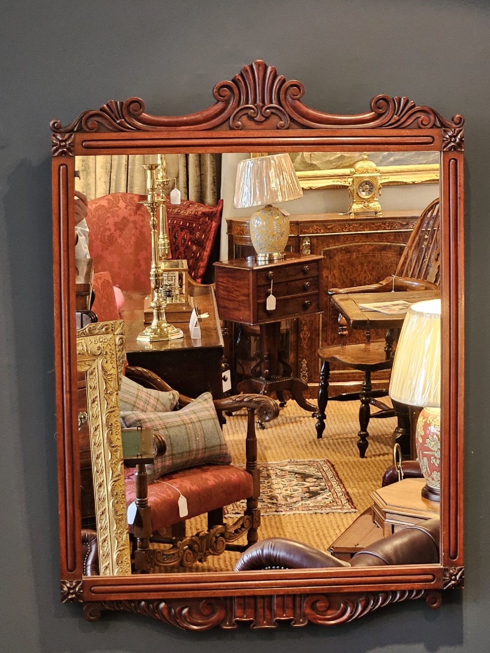 A rectangular Victorian mahogany wall mirror featuring a carved pediment crest and fluted side pillars. View IX