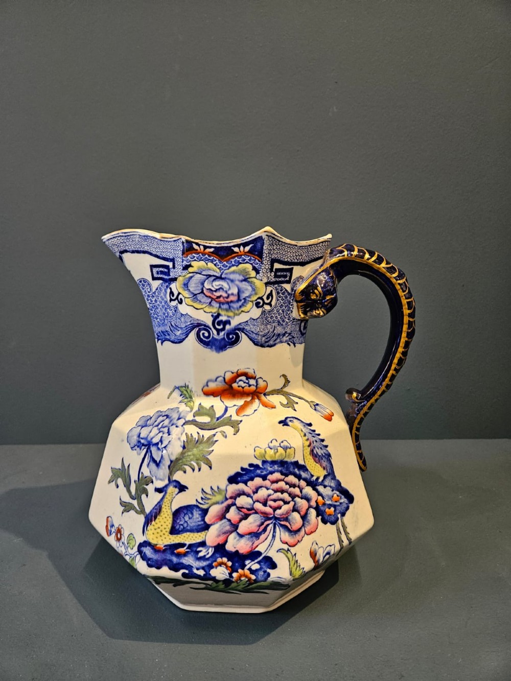 An octagonal Masons ironstone jug and matching wash basin decorated with polychrome floral Chinoiserie patterns and a cobalt blue gilded handle. View II