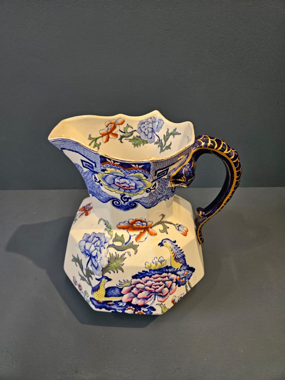 An octagonal Masons ironstone jug and matching wash basin decorated with polychrome floral Chinoiserie patterns and a cobalt blue gilded handle. View VI