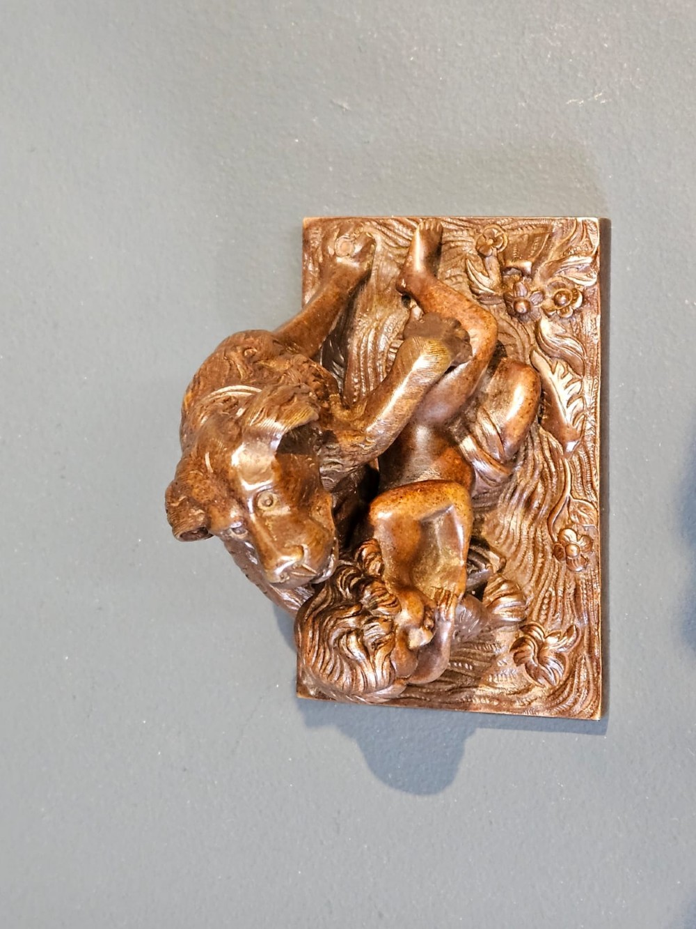An Edwardian bronze sculpture depicting a sleeping child resting beside an alert dog on a rectangular relief base. View V