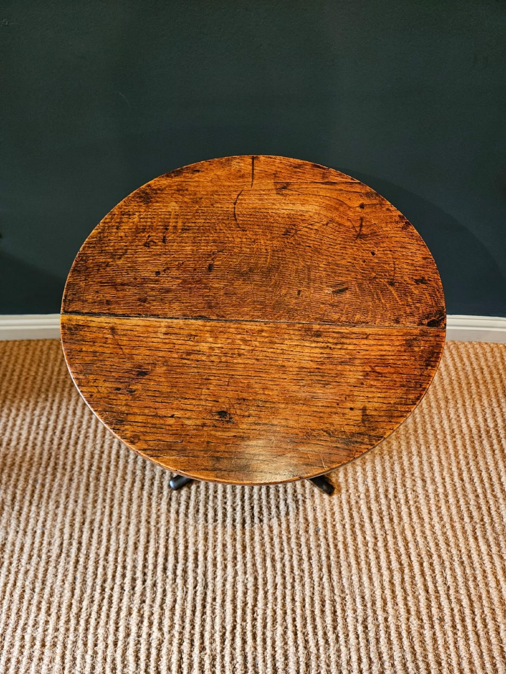 A small George III period oak tripod table featuring a circular top supported by a turned central column and three curved legs. View IV