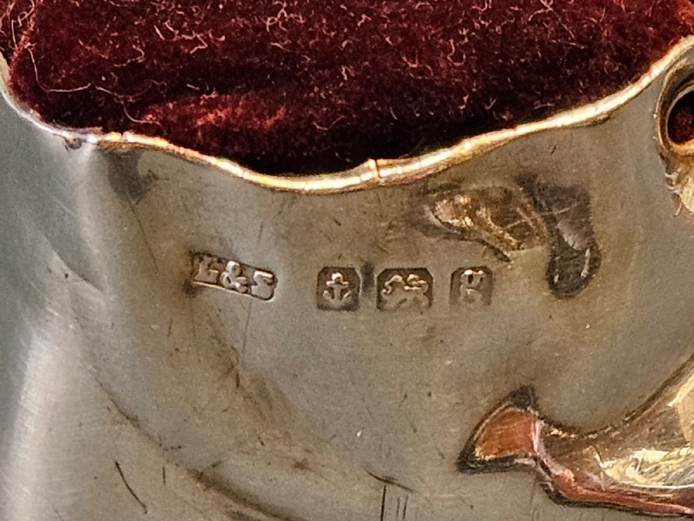 An Edwardian sterling silver pin cushion crafted in the form of a childs boot with a dark red velvet cushion top and cord laces. View III