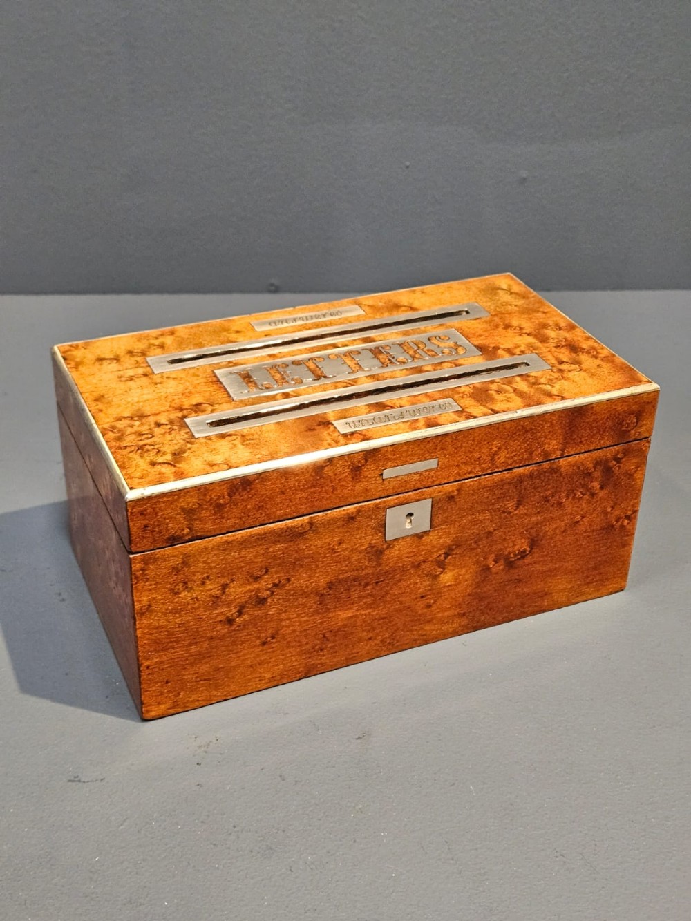 A Victorian burr satinwood desktop post box featuring slotted metal plates labelled letters, answered, and unanswered.