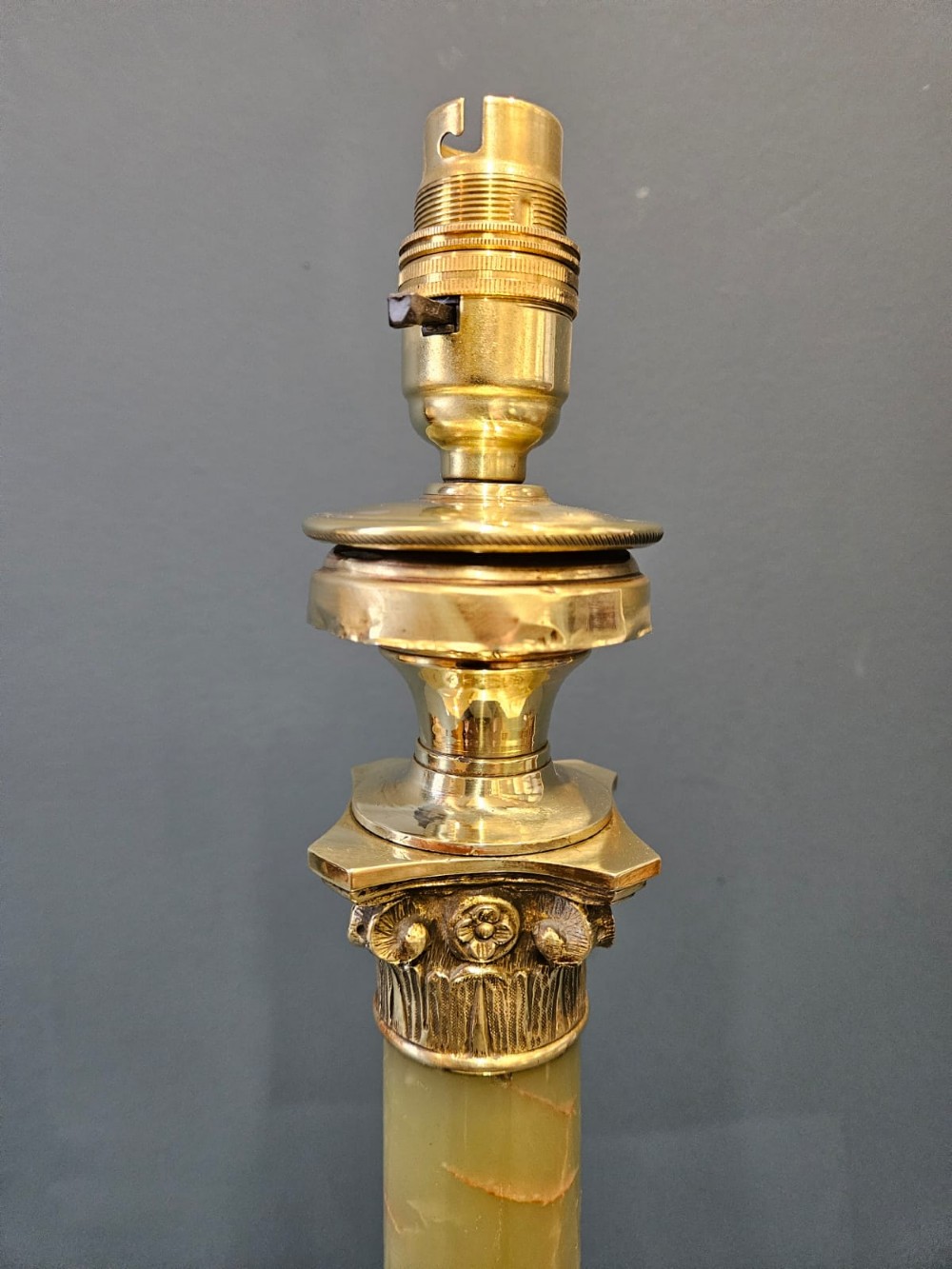 A late Victorian table lamp featuring a brass Corinthian capital, a cylindrical green marble shaft, and a square stepped brass base. View III