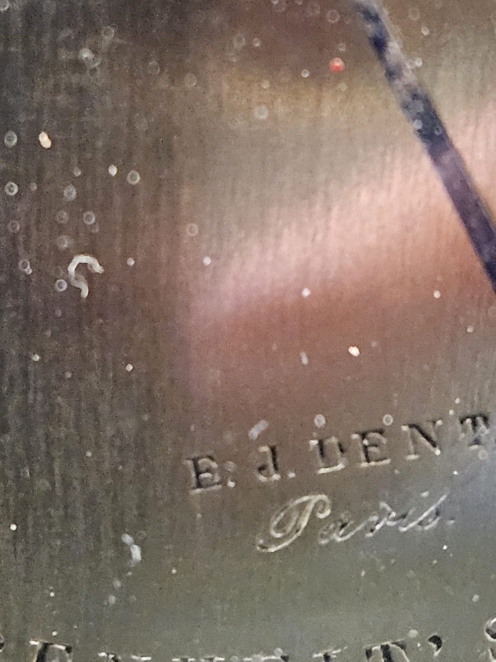 A circular Victorian brass aneroid barometer featuring an engraved face with weather markings, an integrated thermometer, and a top hanging ring. View IV