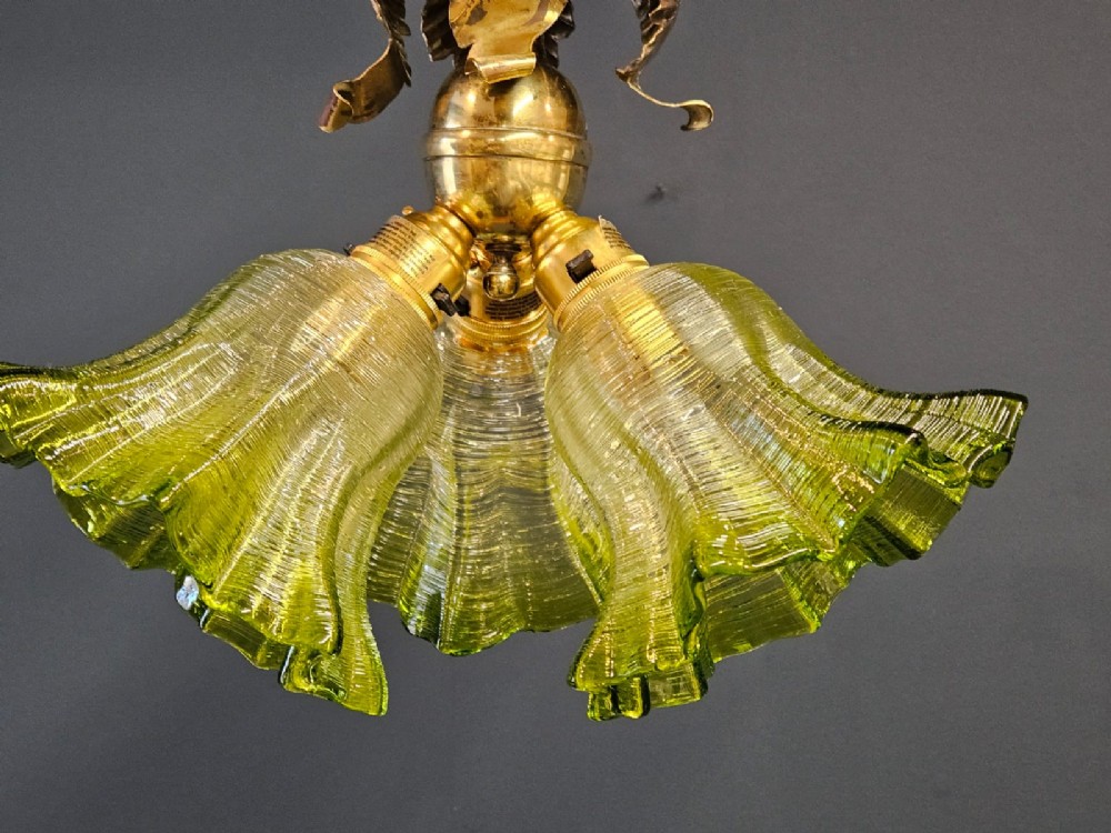 Victorian ceiling light featuring cast brass leaf motifs around the ceiling mount above fluted green glass shades. View IV