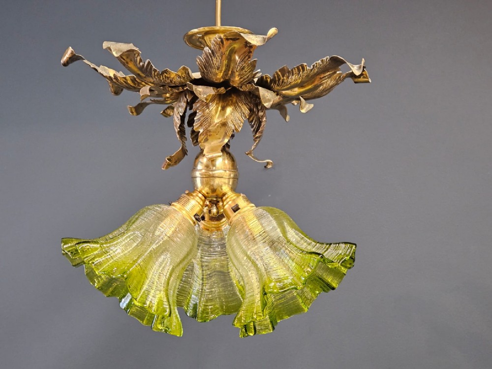 Victorian ceiling light featuring cast brass leaf motifs around the ceiling mount above fluted green glass shades. View VI